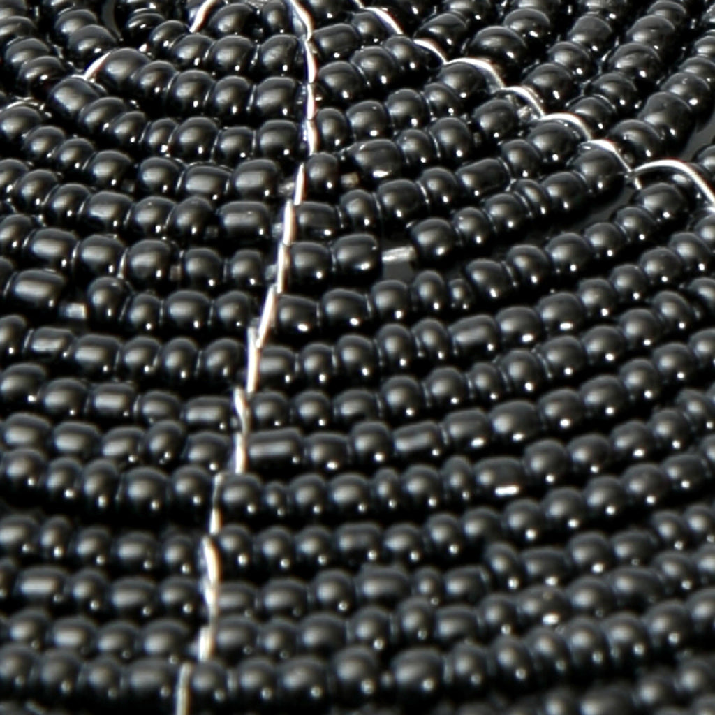 Dessous de verre rond en perles noires motif spirale