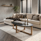Ovaler Couchtisch aus schwarzem Marmor und hellem Holz mit Kreuzgestell – 120x60 cm